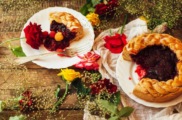 Tart with fresh berries.  Homemade  tart decorated with berries. Food: Cranberry and Raspberry upside down cake. a very natural and easy cake with olive oil and topped with caramelized raspberries