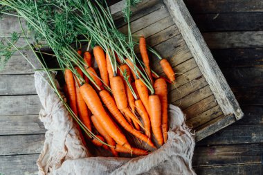 Koyu ahşap masa arka plan üzerinde havuç hasat. taze c aldı
