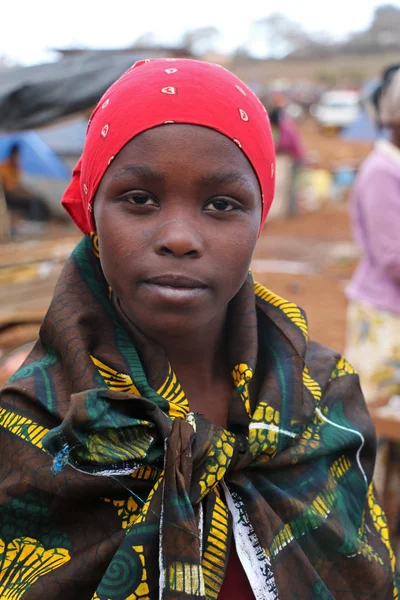 Portrait of African young woman on colourful clothes at Karatu Iraqw Market, Tanzania.