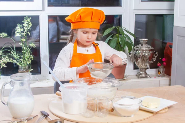 Little Cute Girl Orange Chef Costume Breaks Raw Egg Pours — Φωτογραφία Αρχείου