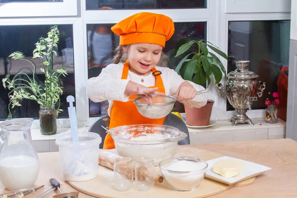 Little Cute Girl Orange Chef Costume Breaks Raw Egg Pours — Φωτογραφία Αρχείου