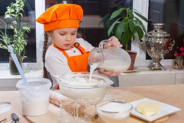 Little Cute Girl Orange Chef Costume Breaks Raw Egg Pours — Φωτογραφία Αρχείου