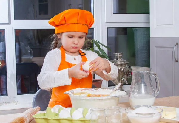 Little Cute Girl Orange Chef Costume Breaks Raw Egg Pours — Φωτογραφία Αρχείου