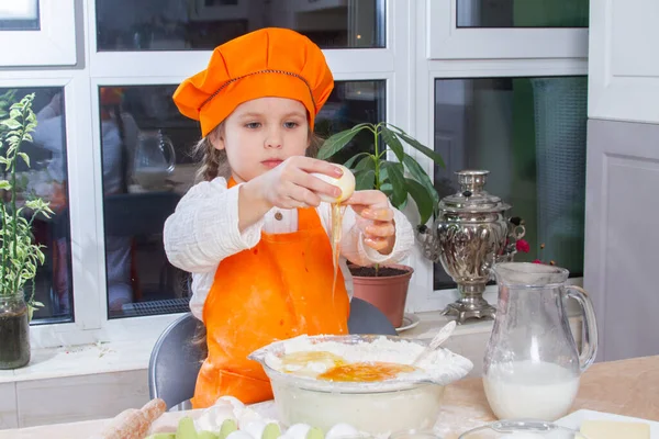 Little Cute Girl Orange Chef Costume Breaks Raw Egg Pours — Φωτογραφία Αρχείου