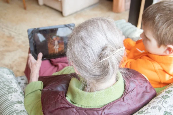 Old European Woman Cute Boy Orange Raglan Sitting Chair Tablet — Stock Photo, Image