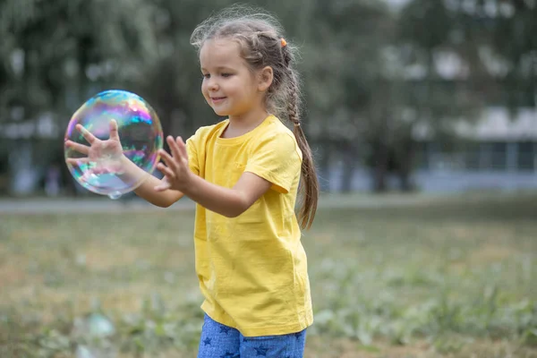 Happy Girl Catches Big Soap Bubbles Child Plays Street Light — 图库照片