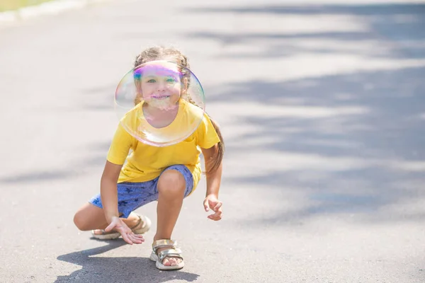 Happy Girl Catches Big Soap Bubbles Child Plays Street Light — 图库照片