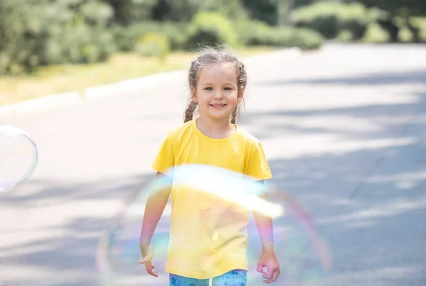 Happy Girl Catches Big Soap Bubbles Child Plays Street Light — 图库照片