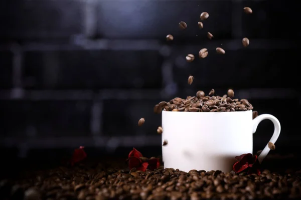 Caindo Grãos Café Uma Caneca Branca Contra Fundo Uma Parede — Fotografia de Stock