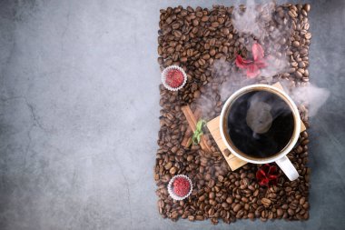 Kırmızı çikolata ve kırmızı çiçekli fotoğraf çerçevesi şeklinde kahve çekirdekleri ile dolu beyaz bir fincanın düz manzarası vardı. Sabah espresso. Kahve kupası..