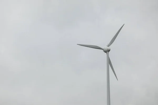 Wind turbines field in a stormy day with strong wind and rain. Wind farm eco field. Green ecological power energy generation.