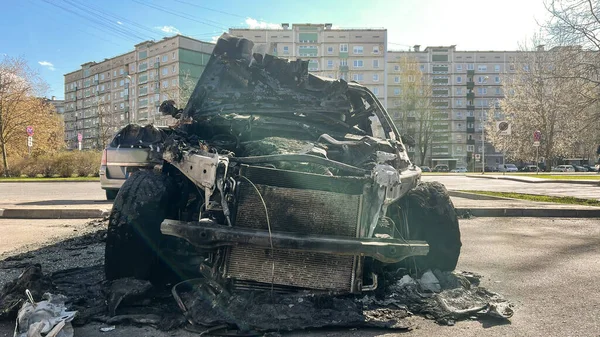 New car burned to the ground in the middle of a sleeping area.