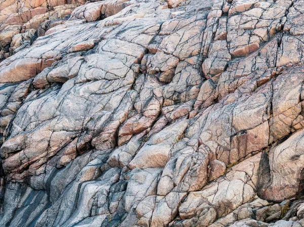 Rock formations - rock layers, close up. Wave texture, a rock formation on the Barents Sea.