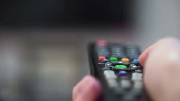 The TV remote buttons close-up. Entertainment on the couch. Switching TV programs — Stock Video