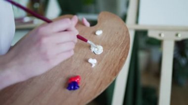 Yetenekli sanatçı palette farklı renkleri karıştırır