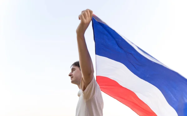 Um homem com a bandeira da França. Patriota nas Olimpíadas. Símbolo nacional acenando — Fotografia de Stock