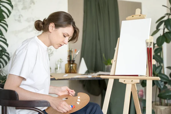 Aprendiendo a dibujar. El estudiante mezcla pinturas al óleo en la paleta. Primer plano —  Fotos de Stock