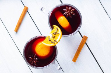 Beyaz tahtalarda sıcak şarap. İki bardak sonbahar şarabı ahşap arka planda kaynatılmış. Noel içkisi. Uzayı kopyala Üst görünüm