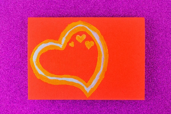 Heart of gold paints on a red postcard. Festive card with hearts on purple glitter background. Valentine s day postcard. Top view