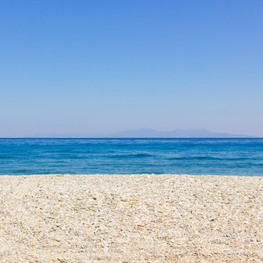 Pebble beach and blue sky. Life balance and harmony. Summer vacation concept. Minimalism