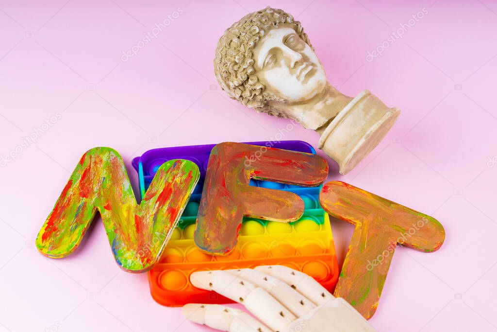 NFT Non-Fungible token. Concept for blockchain system. Classical statue and Pop it toy on a pink background. Crypto art concept with an artificial hand