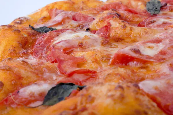Pizza closeup with cheese and tomato — Stock Photo, Image