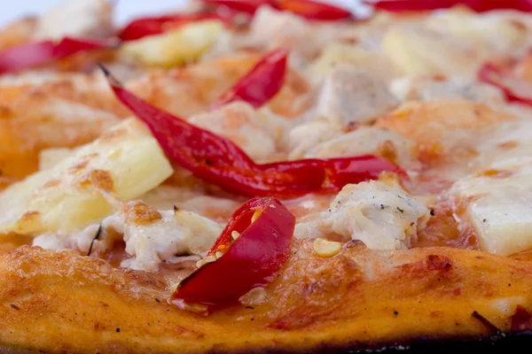 Pizza closeup with hot pepper, cheese and tomato — Stock Photo, Image