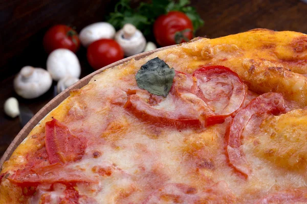 Pizza closeup with cheese and tomato — Stock Photo, Image