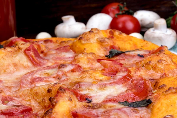 Pizza closeup with cheese and tomato — Stock Photo, Image