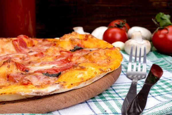 Margarita pizza with cheese and tomatoes on a wooden table — Stock Photo, Image