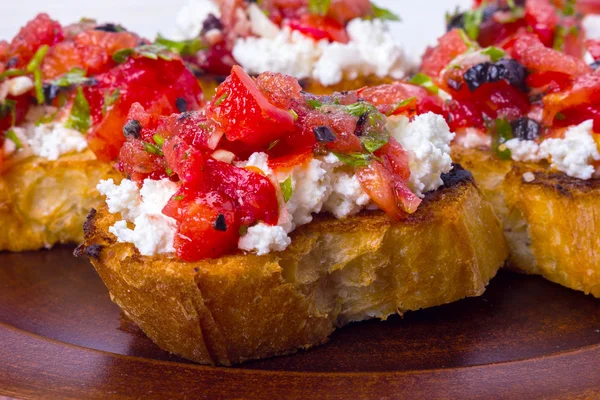 Bruschetta with cheese and tomatoes — Stock Photo, Image