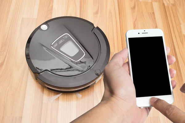Smart phone with Robotic vacuum. — Stock Photo, Image