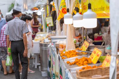 people buy vegetarian food at Yaowarat J Festival Bangkok Chinatown street, shop are decorated with yellow flag with symbols of eat for merit, no animal meat sign. 18 October 2020, Bangkok,THAILAND.