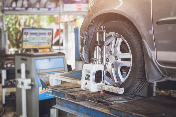 Wheel alignment equipment in a car repair station, Car Steering Wheel  Balancer Calibrate with laser reflector. Car concept Stock Photo - Alamy