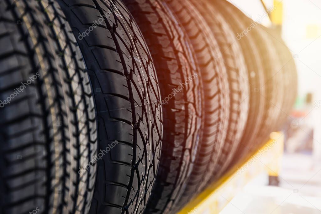 Car tires on shelf in garage shop for sale various type of tyre.