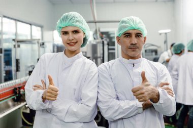 Yiyecek fabrikasında çalışan erkek ve kadın işçilerin portresi. Temiz hijyen beziyle çalışmaktan mutluluk duyarlar. iyi kaliteli ürünler konsepti garanti eder.
