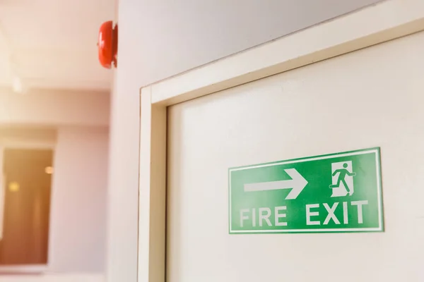 Emergency Fire exit door with alarm bell in condominium and commercial building.