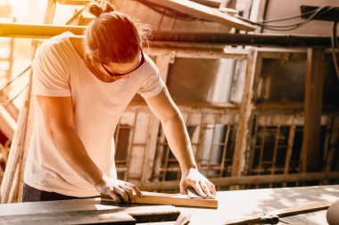 Marangoz erkek işçi çok çalışıyor. Mobilya atölyesindeki şaheser için çalışan profesyonel yüksek yetenekli insanlar..