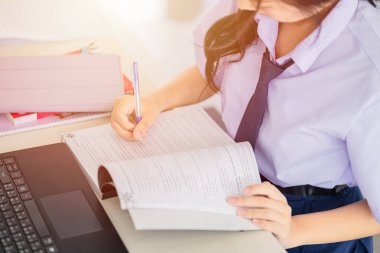 Ödev yapan öğrenci, Asyalı Taylandlı öğrenci üniforması kadın eğitimi kitap yazarak öğreniyor.