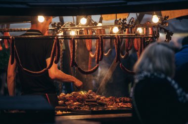 Sausages, salami on the night market in Krakow clipart