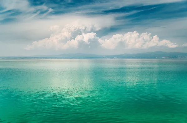 Grote wolk boven de spiegel turkoois Egeïsche zee, Griekenland — Stockfoto