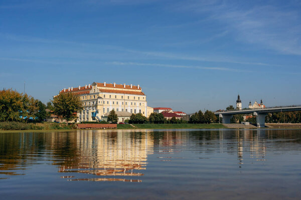 Jesuit collegium building and bridge in Pinsk with reflecrtion in Pina river, Belarus