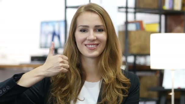 Kciuk w górę przez młoda dziewczyna w pracy, zadowolony siedzi w biurze — Wideo stockowe