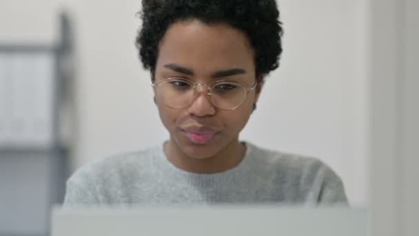 Retrato de mujer africana celebrando mientras usa el ordenador portátil — Vídeos de Stock