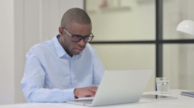 Dizüstü bilgisayarla uğraşırken yorgun Afrikalı Adam Uyuyor