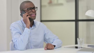 İş yerinde Afrikalı Adam Akıllı Telefonla Konuşuyor 
