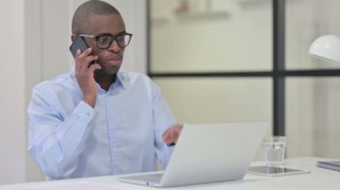 İş yerinde konuşan Afrikalı adam.