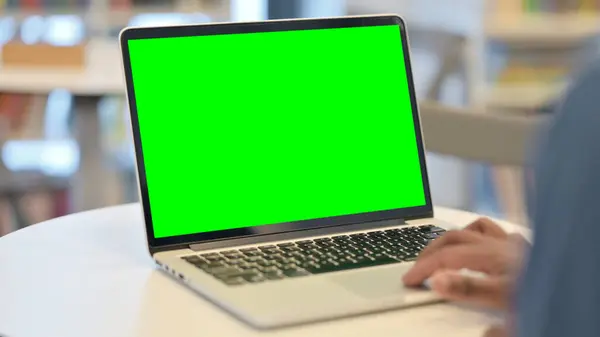 Uomo che utilizza il computer portatile con schermo chiave cromato verde, vista posteriore — Foto Stock