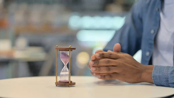 African Hands Near Hourglass, Close Up — 图库照片