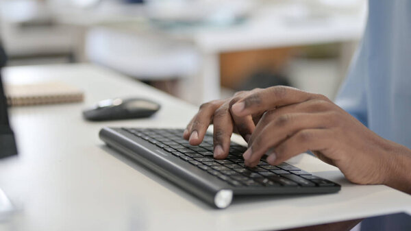 Hands of African Man Typing on Keyboard, Close Up 